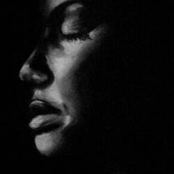 Black and white close-up photograph of a black woman's face.